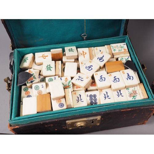 111 - A bone and bamboo mah-Jongg set with instructions and eight game piece holders