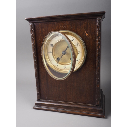 118 - An early 20th century mahogany cased mantel clock with enamelled dial and Arabic numerals, 11