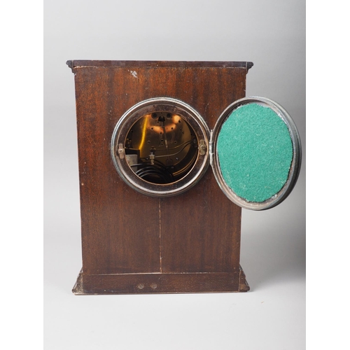 118 - An early 20th century mahogany cased mantel clock with enamelled dial and Arabic numerals, 11