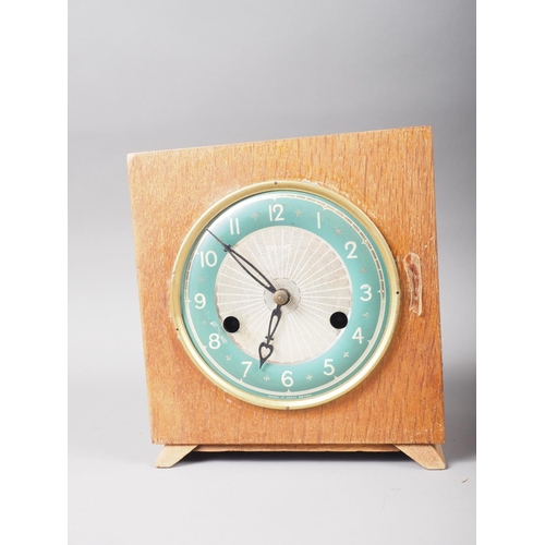 118 - An early 20th century mahogany cased mantel clock with enamelled dial and Arabic numerals, 11