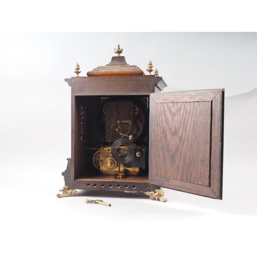 123 - An American mantel clock with brass applied decoration and finials, silvered dial and Roman numerals... 