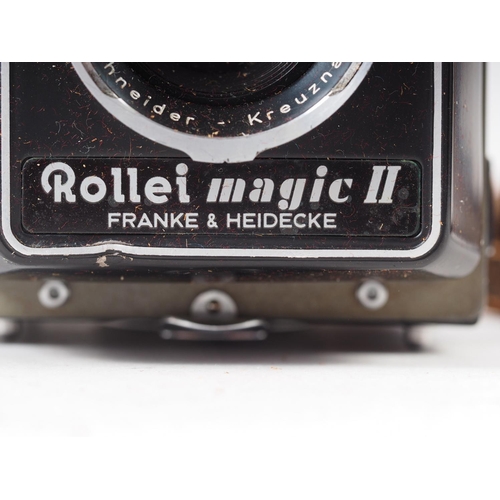 128 - A Rollei Magic II twin lens reflex camera, supplied by Wallace Heaton & Co, in leather case