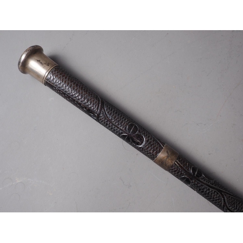 163 - A 19th century Irish bog oak stick with white metal mounts, 36 1/2