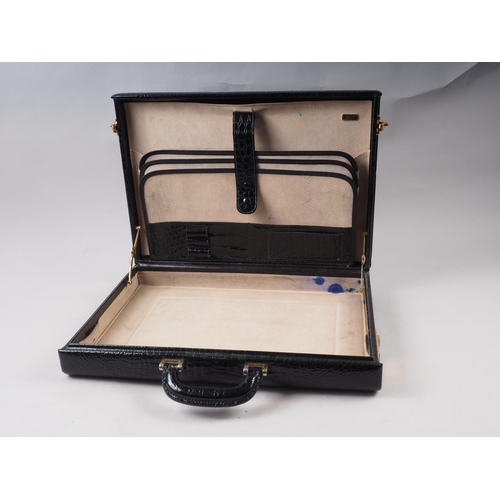 196 - A Bally Italy black crocodile attache case with combination locks and felt dust bag