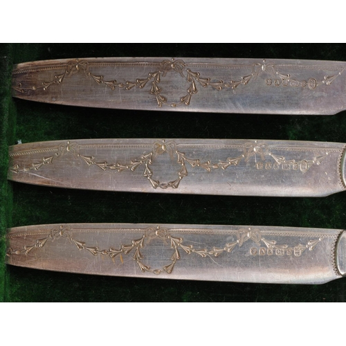 261 - A set of twelve silver plated and engraved mother-of-pearl handled dessert knives and forks, in fitt... 