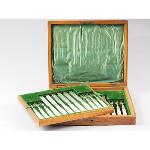 261 - A set of twelve silver plated and engraved mother-of-pearl handled dessert knives and forks, in fitt... 