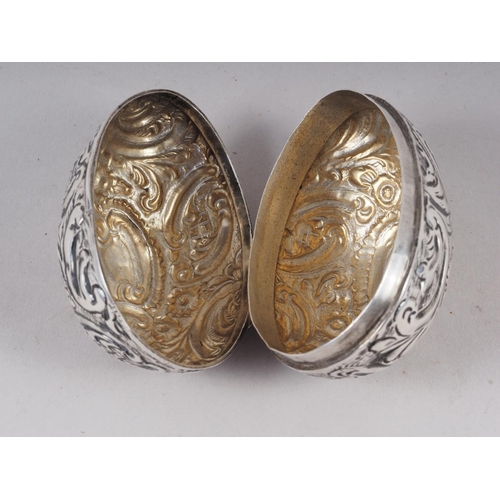 281 - A late 19th century chased and engraved silver egg with parcel gilt interior, marks Nathan and Hayes... 