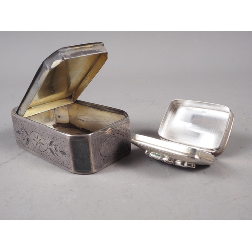 282 - A silver octagonal snuff box with engraved decoration and a white metal pill box with applied cat de... 