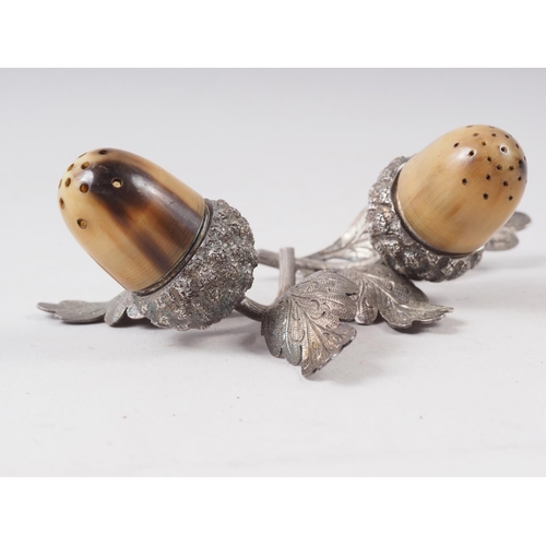 287 - A pair of silver pepper pots, formed as acorns with horn tops, 2 1/2