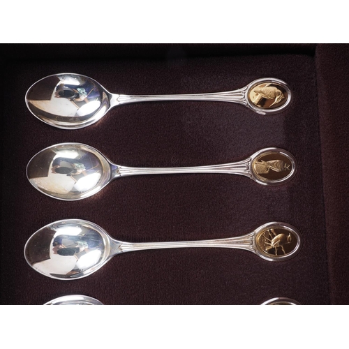 293 - A set of twelve silver and parcel gilt RSPB spoons, in fitted walnut case, 9.6oz troy approx