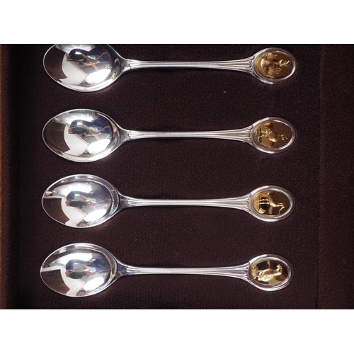 293 - A set of twelve silver and parcel gilt RSPB spoons, in fitted walnut case, 9.6oz troy approx