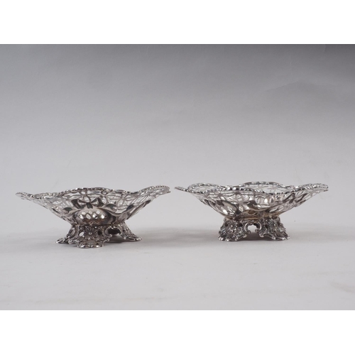 299 - A pair of pierced silver bonbon dishes, on scroll feet, 6.5oz troy approx