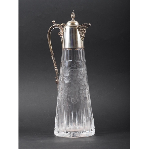 317 - A cut glass claret jug with engraved vine design and silver mounts