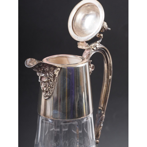 317 - A cut glass claret jug with engraved vine design and silver mounts