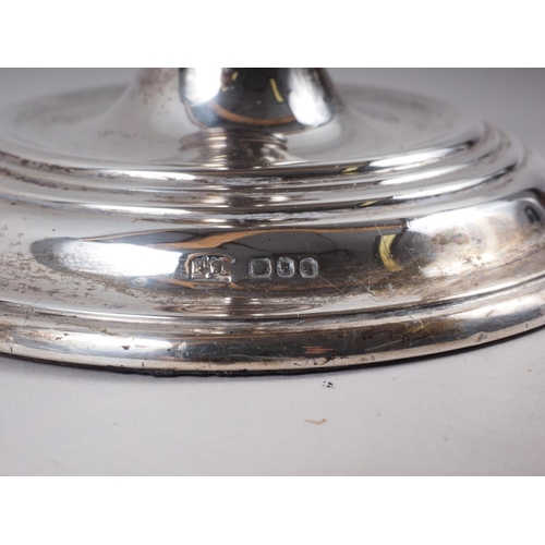 320 - A pair of filled silver candlesticks, on circular bases, 8