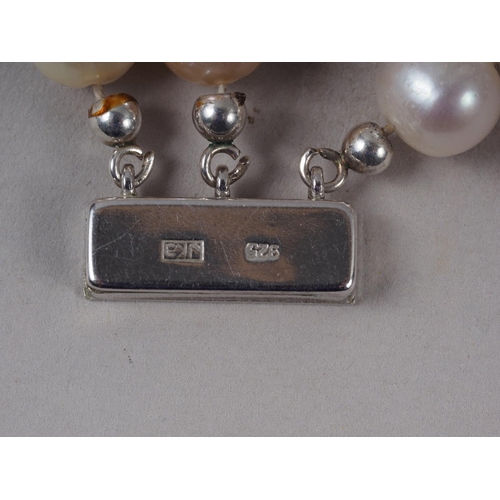 341 - A three-strand cultured pearl necklace with white metal box clasp, stamped 925, 8mm approx average d... 