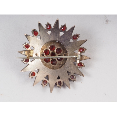 344 - An early 20th century Austro-Hungarian star burst brooch, set facetted garnets, mount unmarked, 44mm... 