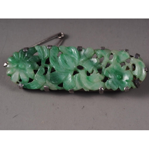 346 - A Chinese floral carved green jade and white metal mounted brooch and a similar bracelet