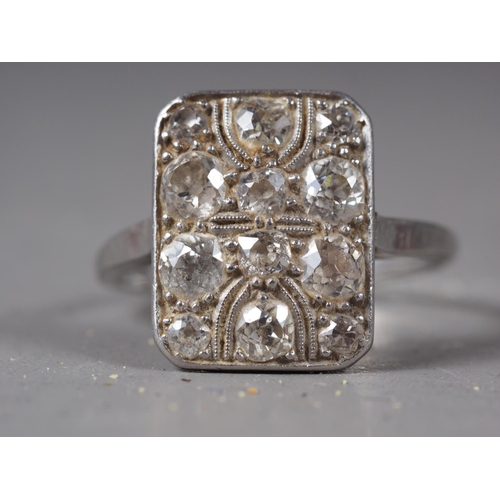 370 - An Art Deco platinum and twelve-stone pave set diamond dress ring, 5.4g, Size between N and O.
Size ... 