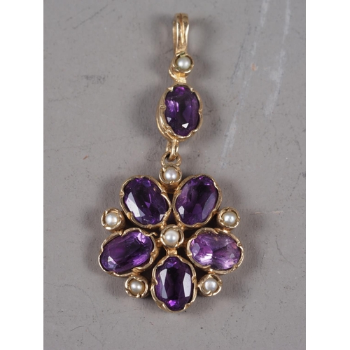 380 - A yellow metal, seed pearl and amethyst pendant