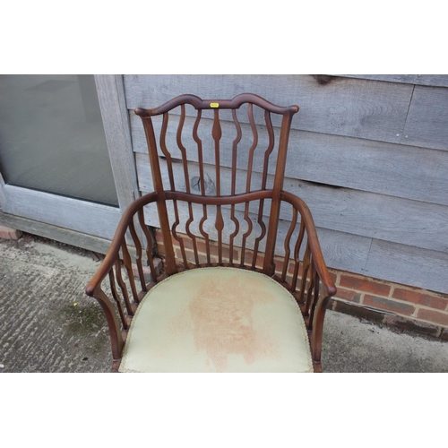 496 - A late 19th century mahogany shaped vertical rail back open armchair with padded seat, on cabriole s... 