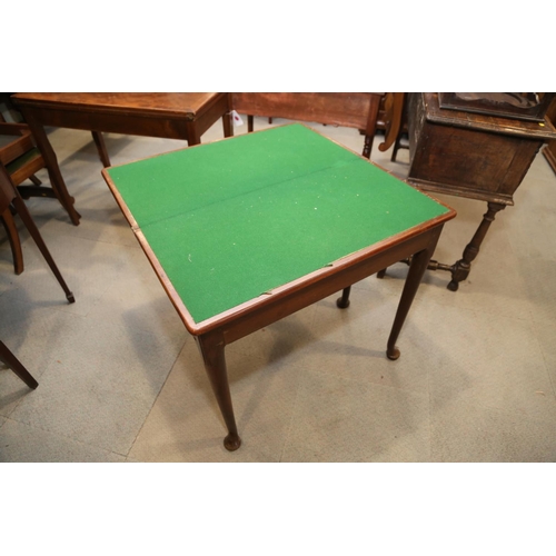 506 - A Georgian mahogany fold-over top card table, on pole turned supports and pad feet, 32