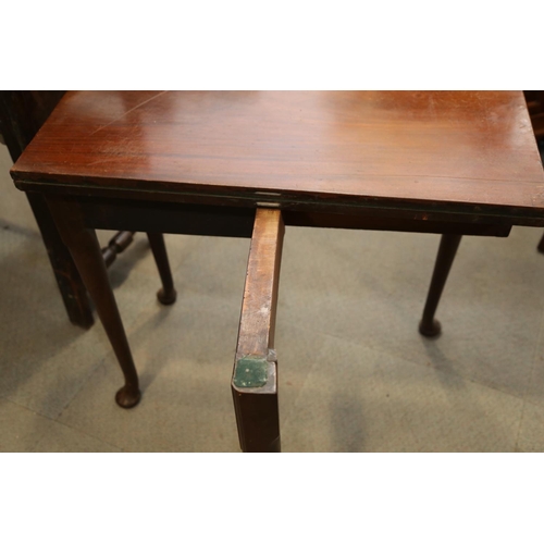 506 - A Georgian mahogany fold-over top card table, on pole turned supports and pad feet, 32