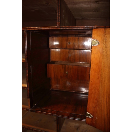 508 - An early Georgian figured walnut and feather banded cupboard of drawers, the upper section fitted tw... 