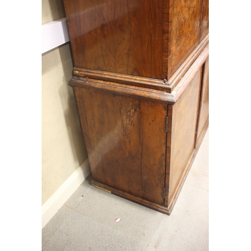 508 - An early Georgian figured walnut and feather banded cupboard of drawers, the upper section fitted tw... 