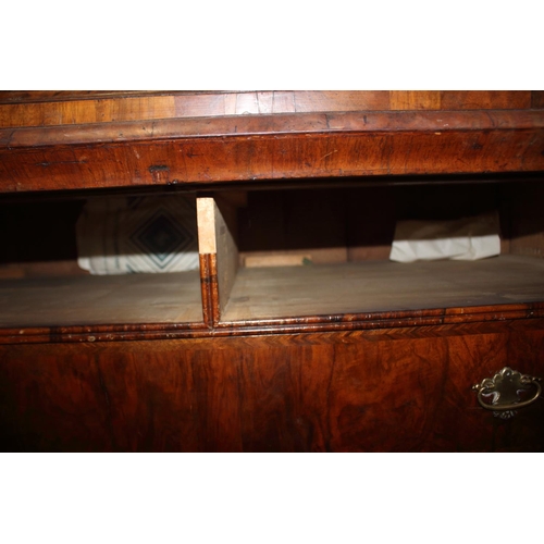 508 - An early Georgian figured walnut and feather banded cupboard of drawers, the upper section fitted tw... 