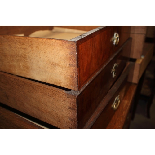 508 - An early Georgian figured walnut and feather banded cupboard of drawers, the upper section fitted tw... 