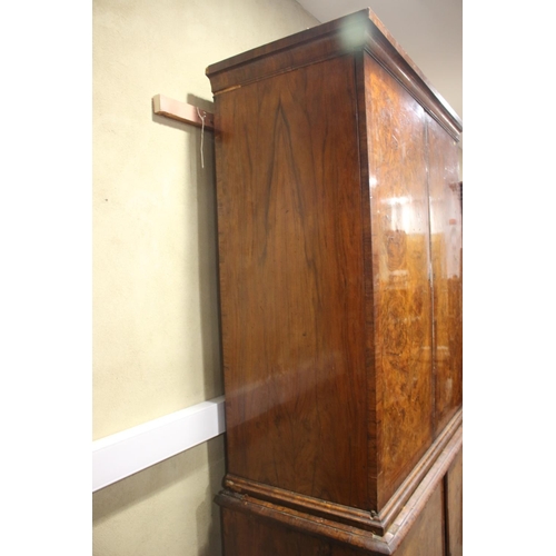 508 - An early Georgian figured walnut and feather banded cupboard of drawers, the upper section fitted tw... 