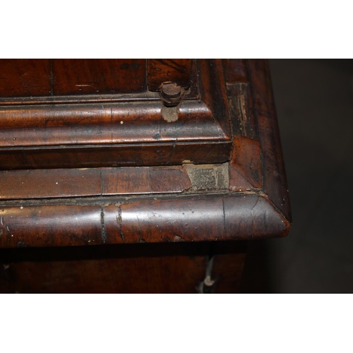 508 - An early Georgian figured walnut and feather banded cupboard of drawers, the upper section fitted tw... 