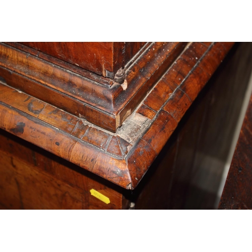 508 - An early Georgian figured walnut and feather banded cupboard of drawers, the upper section fitted tw... 