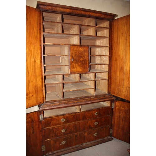 508 - An early Georgian figured walnut and feather banded cupboard of drawers, the upper section fitted tw... 