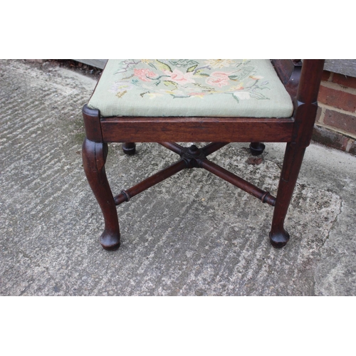 509 - A Georgian oak provincial corner elbow chair with needlework seat, on turned and cabriole supports