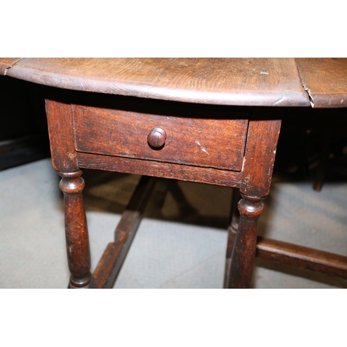 511 - A 19th century oak oval gate leg dining table, on turned and stretchered supports, 48