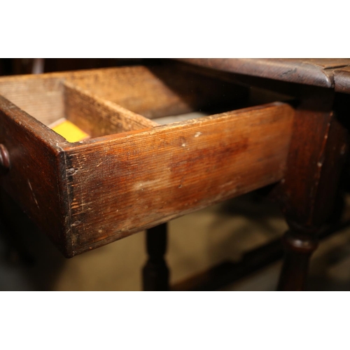 511 - A 19th century oak oval gate leg dining table, on turned and stretchered supports, 48