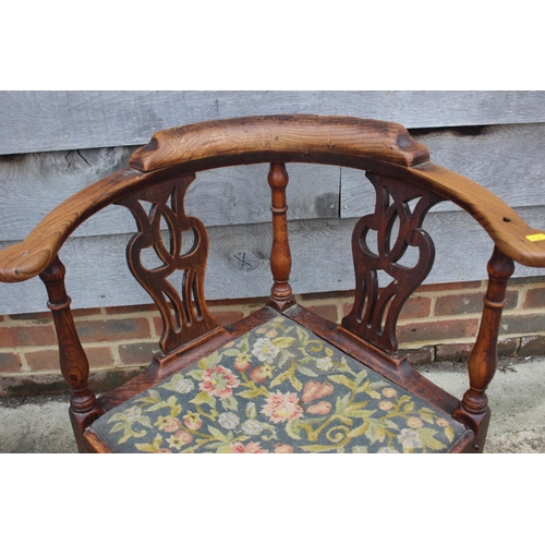 515 - A late 18th century carved mahogany corner elbow chair with needlepoint seat, on square taper and st... 