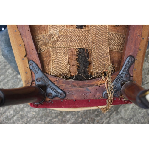 519 - A 19th century low seat nursing chair, on turned supports