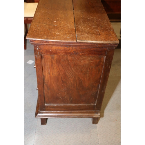 522 - An early 18th century oak chest of three long drawers with fielded panel fronts and brass drop handl... 