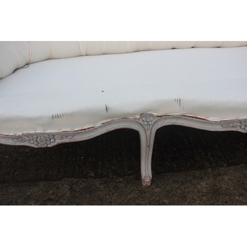 528 - A dove grey painted showframe settee of Louis XVI design, button upholstered in a cotton ticking wit... 