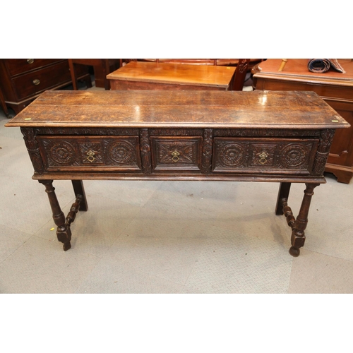 546 - An antique carved oak dresser base, fitted three drawers, on turned and stretchered supports, 57