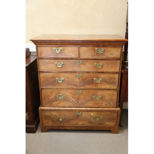 548 - A Georgian figured walnut and feather banded chest on stand, the upper section fitted two small and ... 