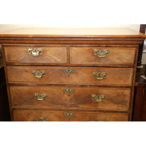 548 - A Georgian figured walnut and feather banded chest on stand, the upper section fitted two small and ... 