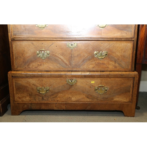 548 - A Georgian figured walnut and feather banded chest on stand, the upper section fitted two small and ... 