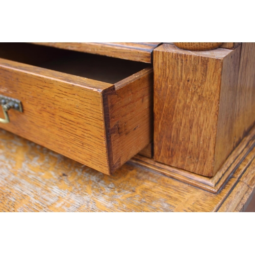 550 - A late 19th century light figured oak bookcase, the upper section fitted deep cornice over two leade... 