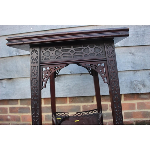 558 - A late 19th century carved mahogany fretwork two-tier patience table, on splay supports, 20