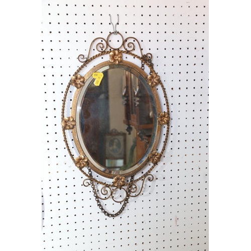 577 - An Art Deco design anodised brass oval-shaped wall mirror with bevelled plate, 17 1/2