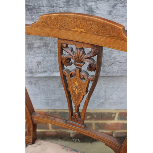 584 - An Edwardian rosewood and inlaid splat back nursing chair with floral needlepoint seat, on turned su... 